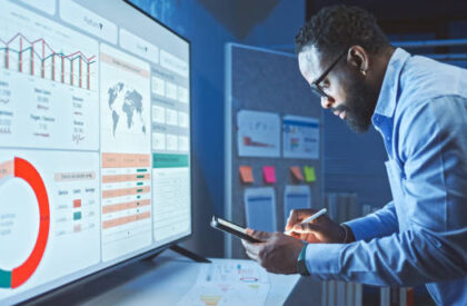 A  Man Reviews the Data Analysis of Marketing from Social Media Platforms.